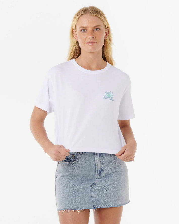 Rip Curl Women's Sunrise Crop Tee in white on model in blue denim skirt from front