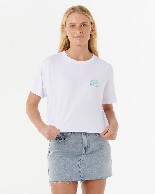 Rip Curl Women's Sunrise Crop Tee in white on model in blue denim skirt from front