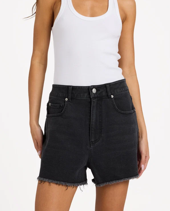Roxy Eva Denim Shorts in black on model in white tank from front close up