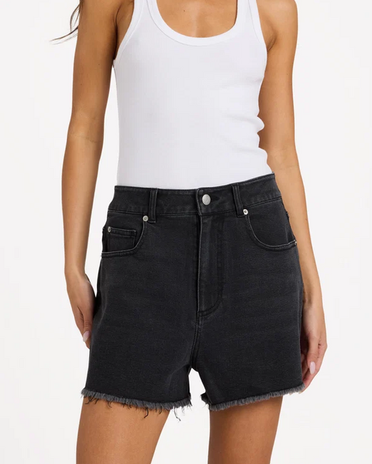 Roxy Eva Denim Shorts in black on model in white tank from front close up