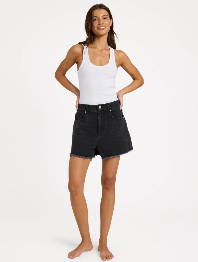 Roxy Eva Denim Shorts in black on model in white tank from front