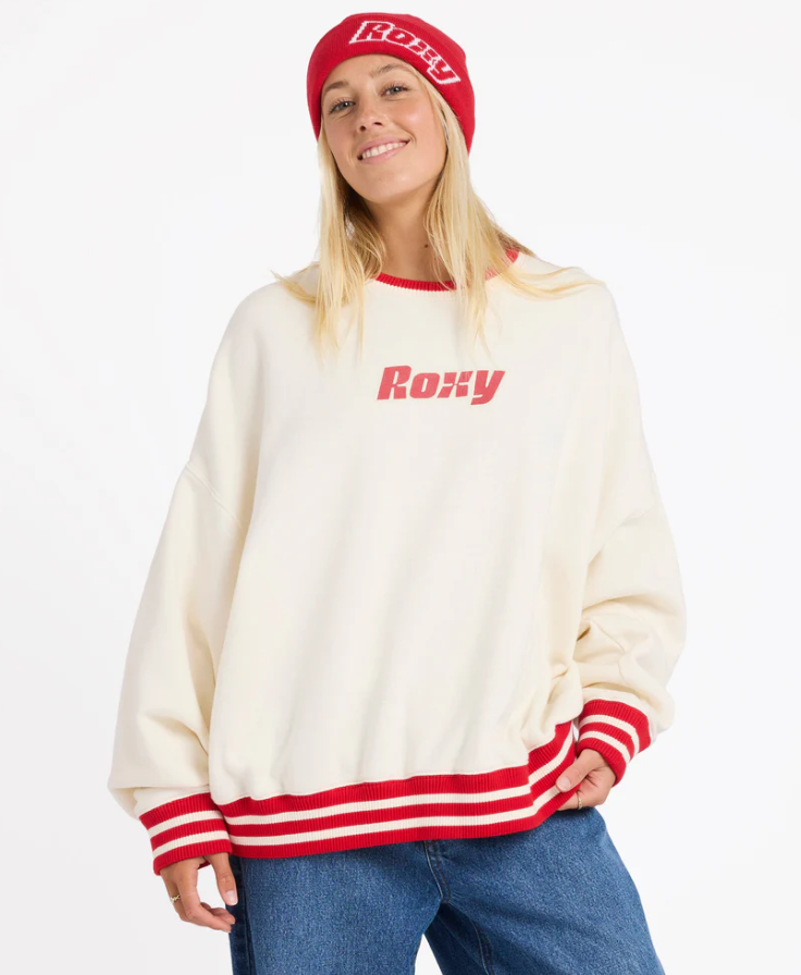 Roxy Game Time Women's Crew in bone colourway with red trim on model in blue Roxy jeans from front close up