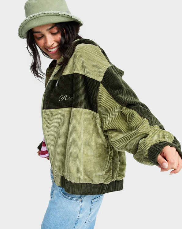 Roxy Have A Blast Womens Cord Jacket
  in oil green on model in blue jeans and pink striped Roxy tee from side