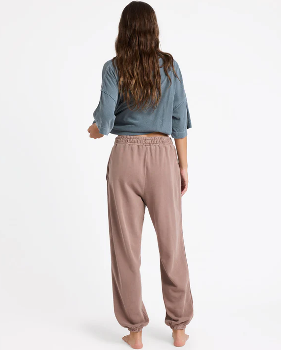 Roxy Steppin Up Trackie Pants in mocha colourway on model in blue Roxy tee from rear