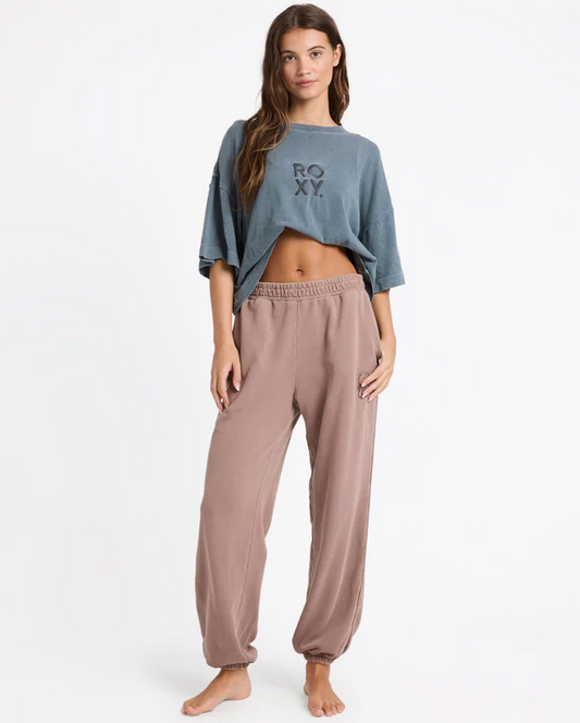 Roxy Steppin Up Trackie Pants in mocha colourway on model in blue Roxy tee from front 