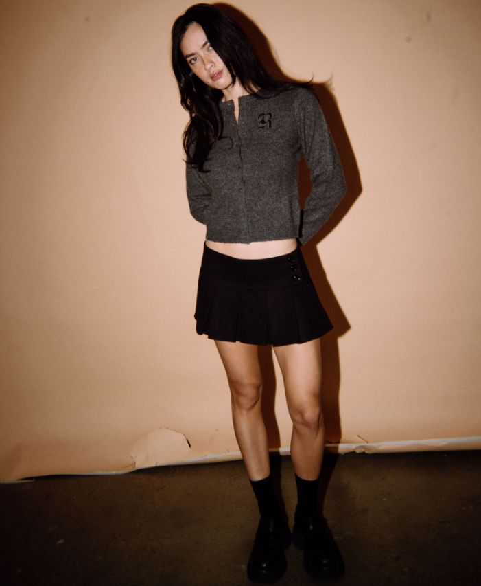 Rusty Academy Women's Cardigan in charcoal marle on model in black skirt from front