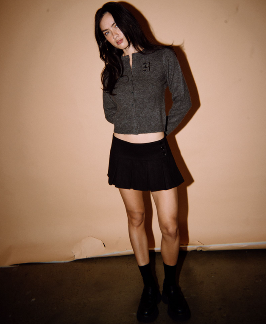 Rusty Academy Women's Cardigan in charcoal marle on model in black skirt from front