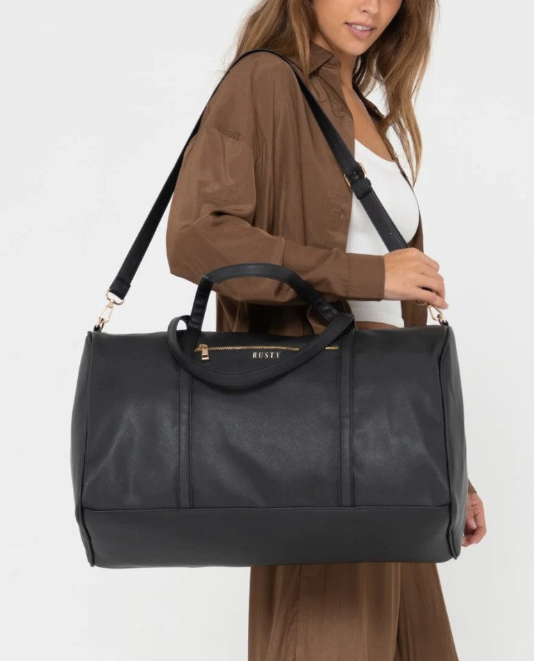 Rusty Bambi Weekender Bag in black on shoulder of a model