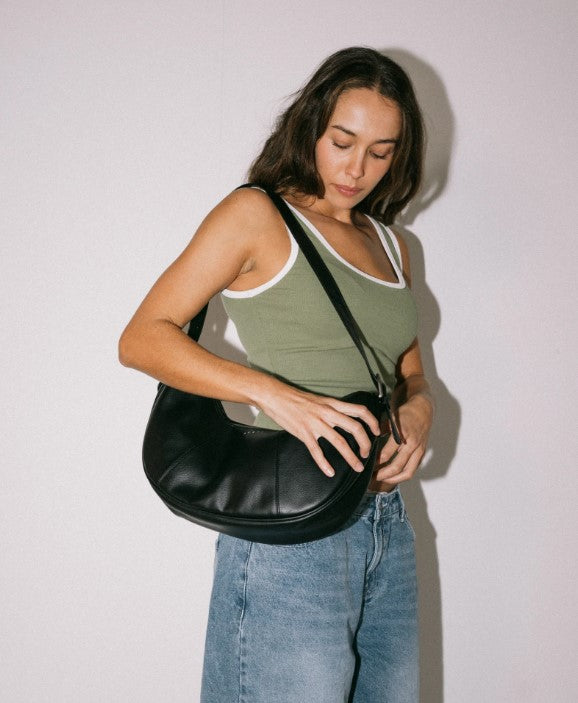 Rusty Bella Shoulder Bag in black being held by model