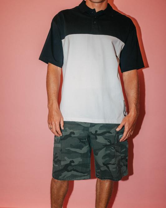 Rusty Commando 23" Cargo Shorts in overdyed camo colourway on model in white and black polo