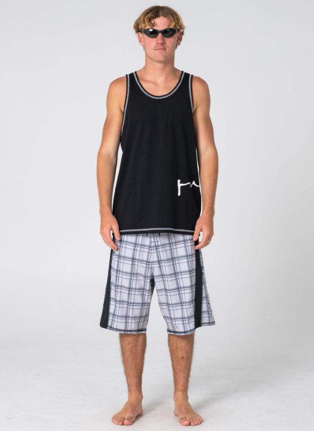 Rusty Crisis Men's Tank in black on model in check boardshorts from the front