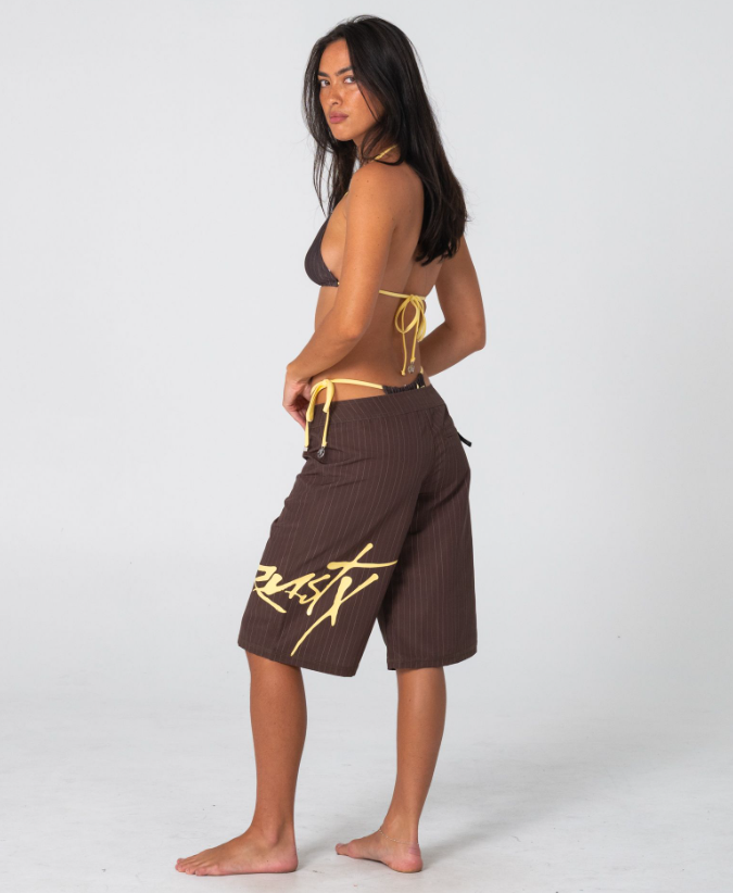Rusty Cyberpunk Fixed Waist 22" Women's Boardshorts in java with yellow colourway on model from the side