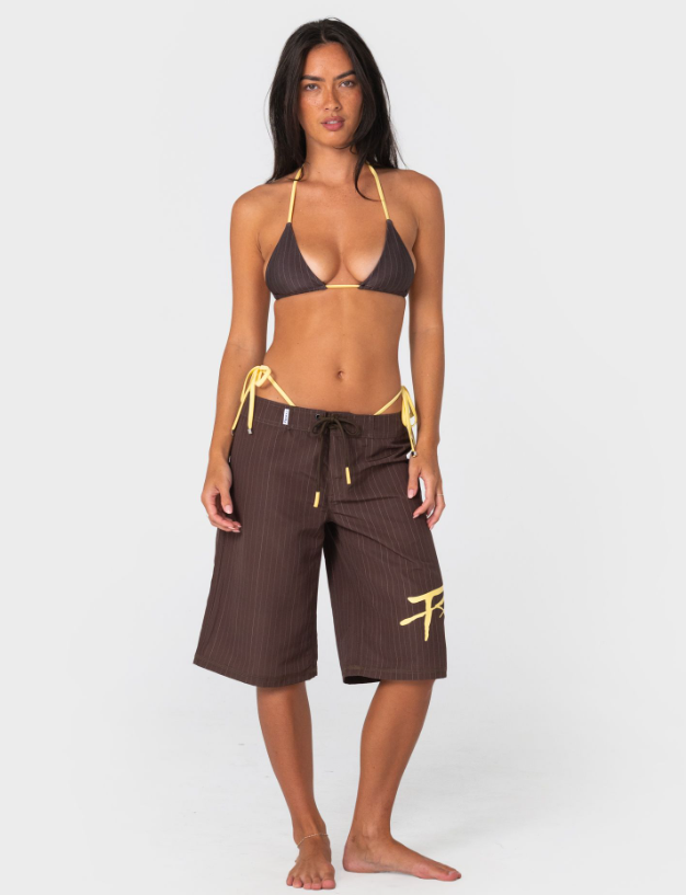 Rusty Cyberpunk Fixed Waist 22" Women's Boardshorts in java with yellow colourway on model from the front