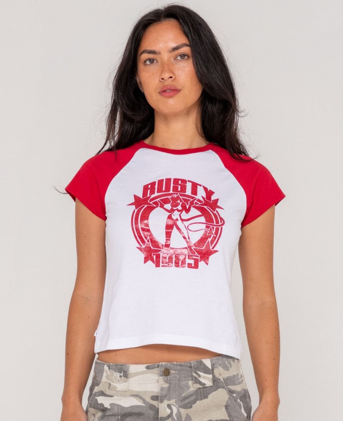 Rusty Daring Devil Cap Sleeve Womens Baby Tee in white with red sleeves and print on dark-haired model from front
