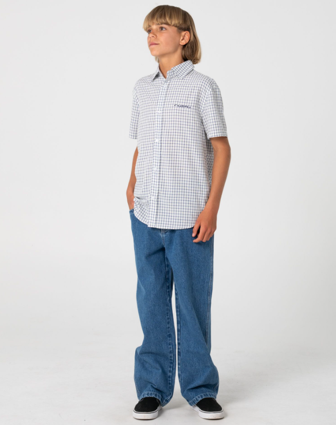 Rusty Defender Boys Short Sleeve Shirt in cream check on model in blue jeans from the front