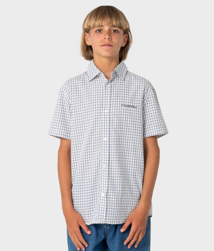 Rusty Defender Boys Short Sleeve Shirt in cream check on model in blue jeans from the front close up