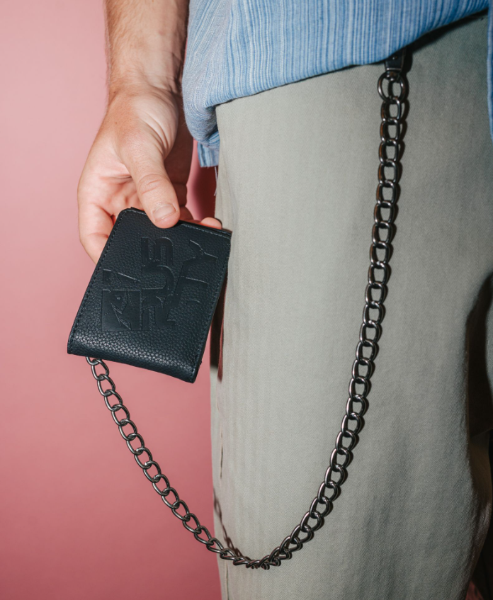 Rusty District Chain PU Wallet in black being hold by a man in beige pants