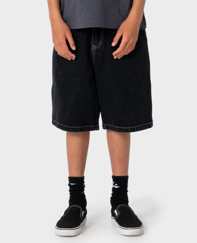 Rusty Dr Dot Baggy Boys Denim Shorts in blackout colour on boy in Rusty t-shirt from the front close up