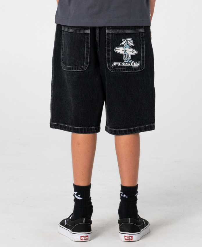 Rusty Dr Dot Baggy Boys Denim Shorts in blackout colour on boy in Rusty t-shirt from rear close up