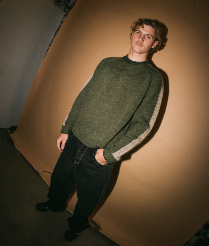 Rusty Fishermans Boxy Knitted Crew in shadow army on model from front with brown background