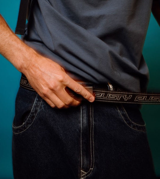 Rusty Flip Daddy Reversible Webbing Belt in black and white on man's dark blue jeans loops