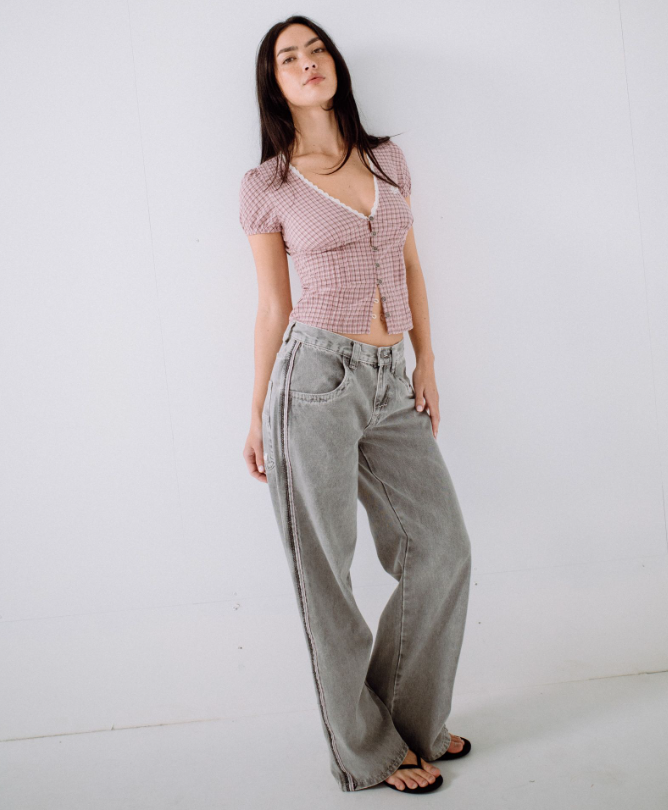 Rusty Flip Mommy Low Rise Wide Denim Jeans in london summer grey colourway with pink details on model from front