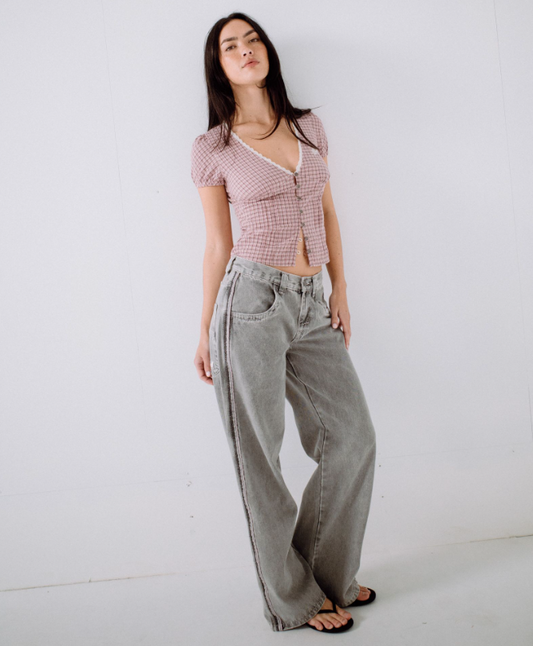 Rusty Flip Mommy Low Rise Wide Denim Jeans in london summer grey colourway with pink details on model from front