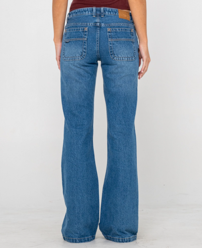 Rusty Freida Flare Low Rise Women's Jeans in blasted middie blue from rear