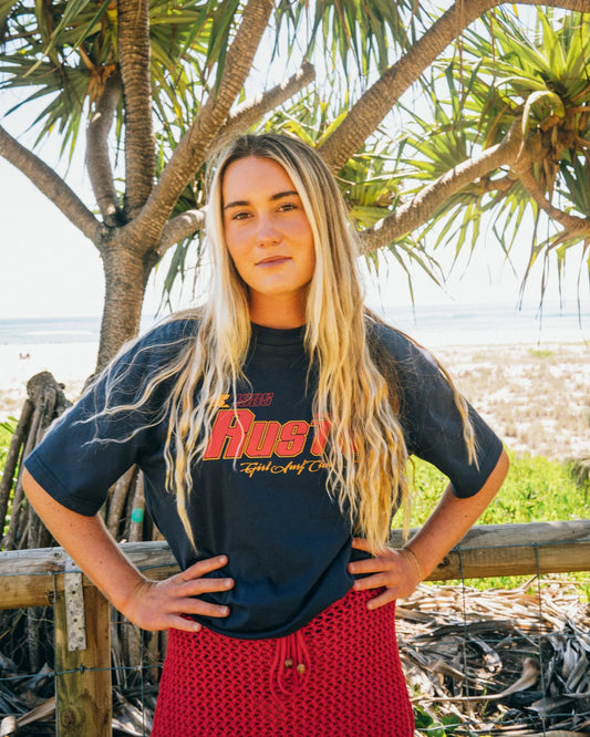 Rusty Girls Surf Club Oversize Tee in navy blue from front on model outside at the beach