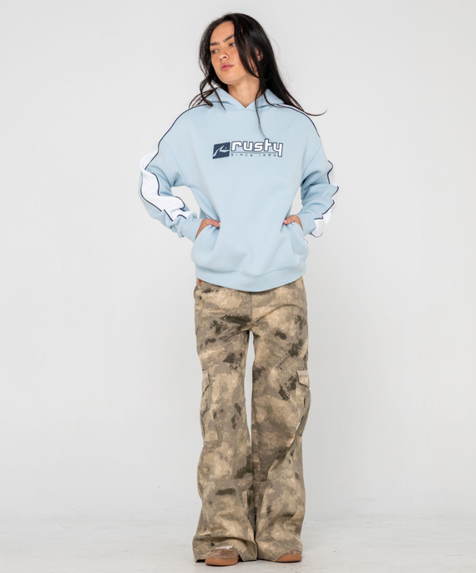 Rusty Hailstone Oversized Hooded Fleece in retro blue on model from front wearing camo jeans