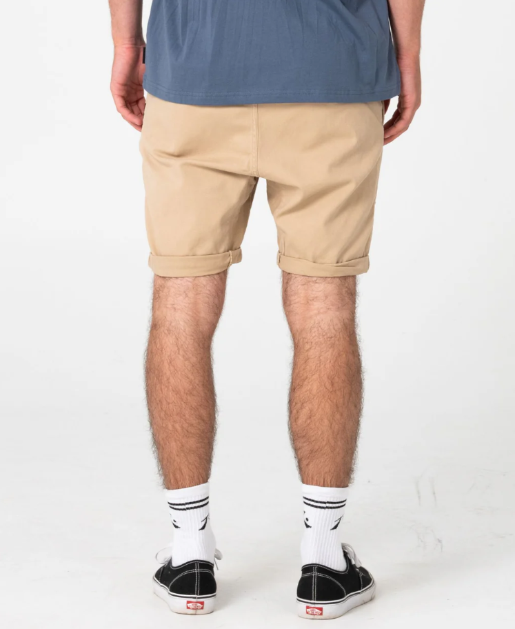 Rusty Hooked On 18" Elastic Walkshorts
 in khaki on model in blue tee from the rear