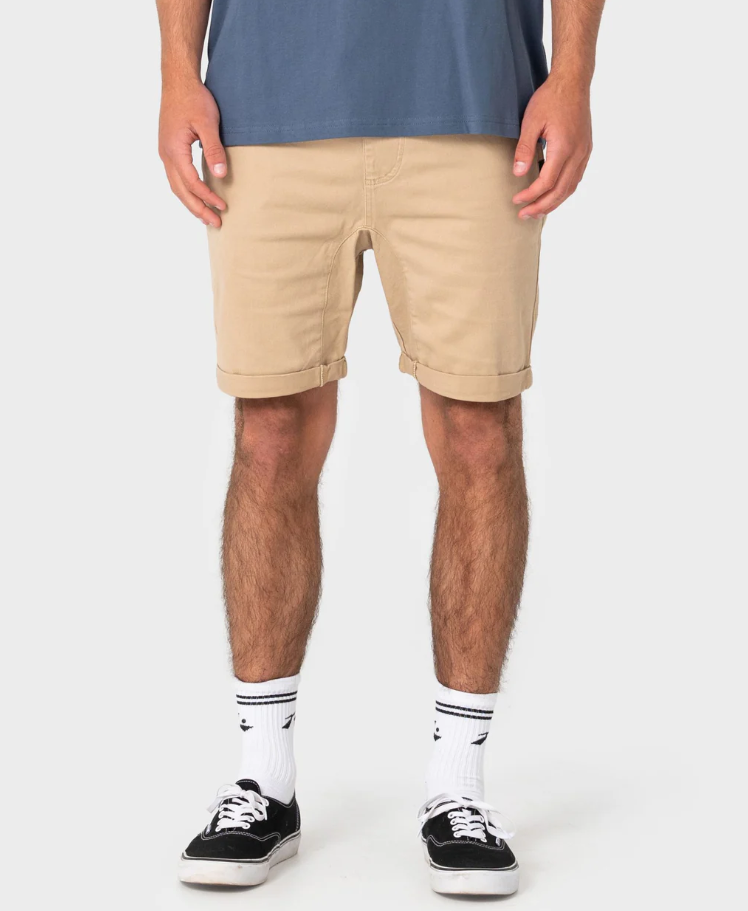 Rusty Hooked On 18" Elastic Walkshorts
 in khaki on model in blue tee from the front close up