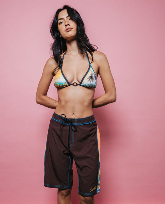 Rusty La Cabana Low Rise Long Womens Boardshorts in java colourway on model in multi coloured bikini top