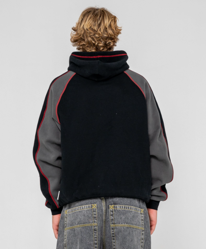 Rusty Paneka Hooded Fleece in bklack with carbon coloured arms and red stitching on model from rear