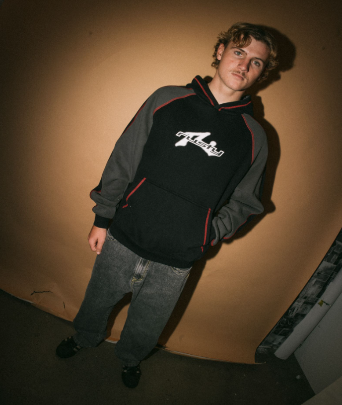 Rusty Paneka Hooded Fleece in bklack with carbon coloured arms and red stitching on model from front