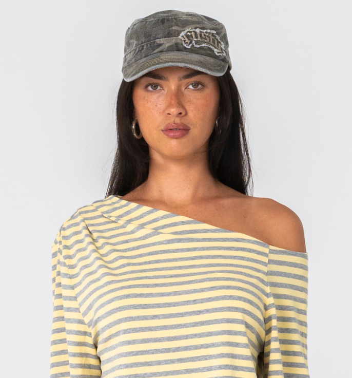 Rusty Punked Camo Military Cap on model in mini shorts and striped tee from the front close up