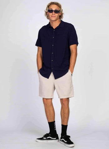 Rusty Razor Blade Short Sleeve Shirt in navy blue colourway on model wearing shorts