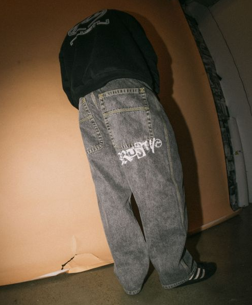 Rusty Redemption Baggy Jeans in washed black from rear showing leg screen print