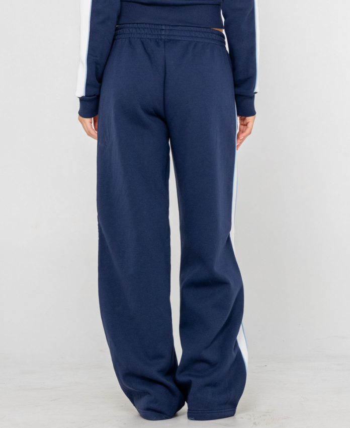 Rusty Retro Lines Wide Leg Women's Track Pants in navy with white side stripe on model  from rear close up