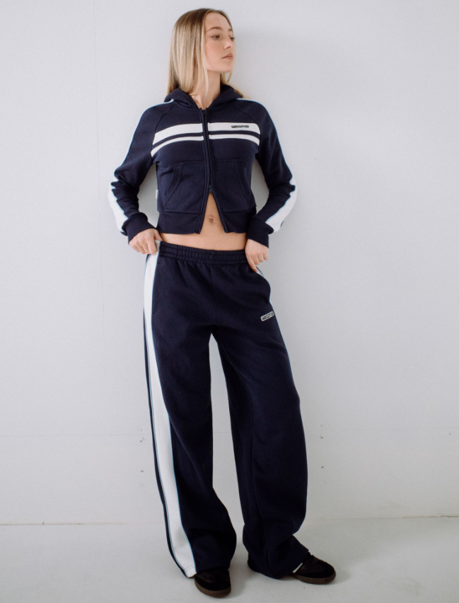 Rusty Retro Lines Wide Leg Women's Track Pants in navy with white side stripe on model from front