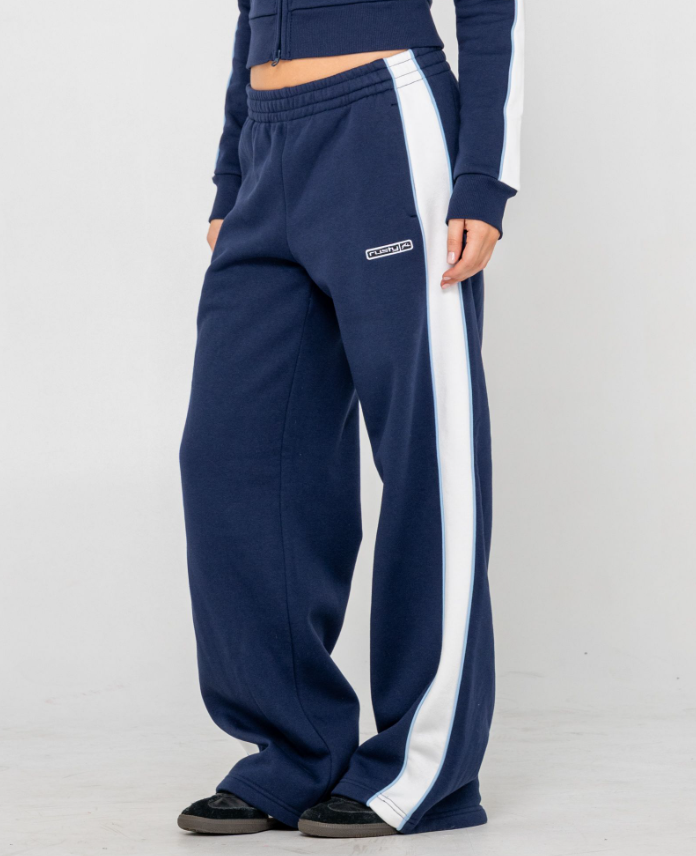 Rusty Retro Lines Wide Leg Women's Track Pants in navy with white side stripe on model from side