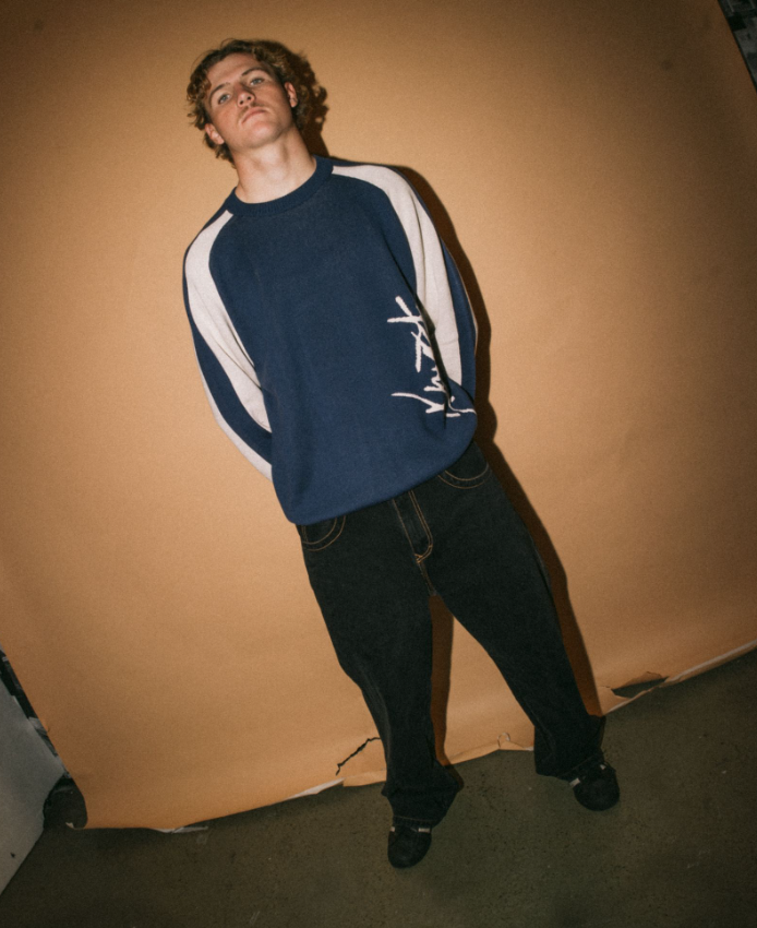 Rusty Roll Safe Boxy Knitted Men's Crew in blue with white detail on model with brown background