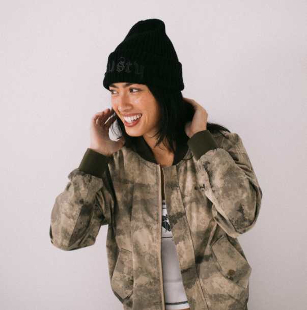 Rusty Roxanne Women's Beanie in black on woman model in pu jacket