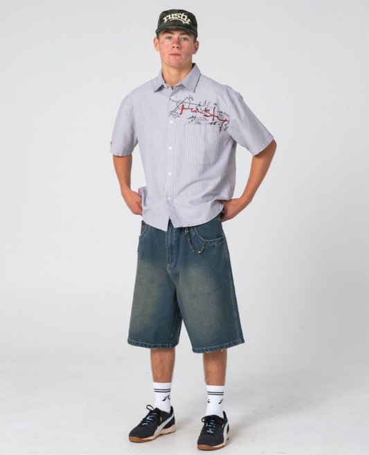 Rusty Shockwave Short Sleeve Shirt in grey colourway on model in blue denim shorts