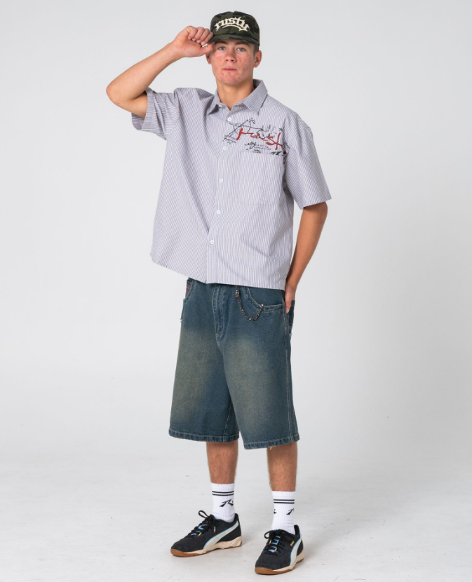 Rusty Shockwave Short Sleeve Shirt in grey colourway on model in blue denim shorts from front