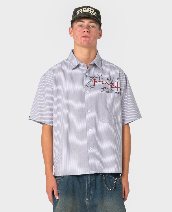 Rusty Shockwave Short Sleeve Shirt in grey colourway on model in blue denim shorts from front close up