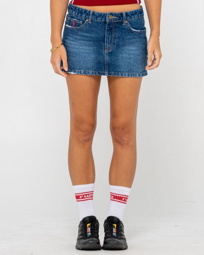 Rusty Shorty Low Rise Denim Micro Mini Skirt in blasted deep sea blue colourway on model in maroon top from front