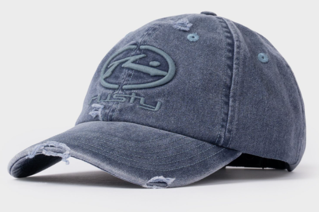 Rusty Split Seam Dad Cap in navy blue showing embroidered logo and distressed material from front/side angle
