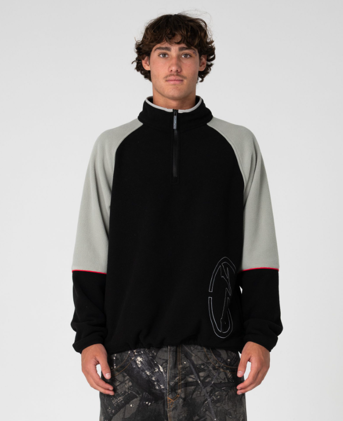 Rusty Tectonic Quarter Zip Polar Fleece in black on model from front
