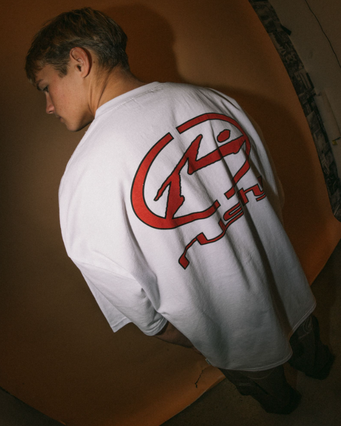 Rusty Turbo Men's T-Shirt in white on model wearing dark jeans from rear